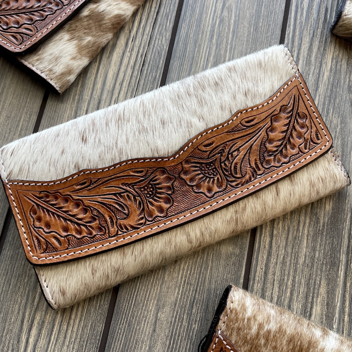 This custom wallet is the perfect choice for any fashion-conscious woman looking for a unique and practical accessory. Made from premium cowhide leather, this western wallet features a beautiful hand-tooled design that's sure to turn heads.
